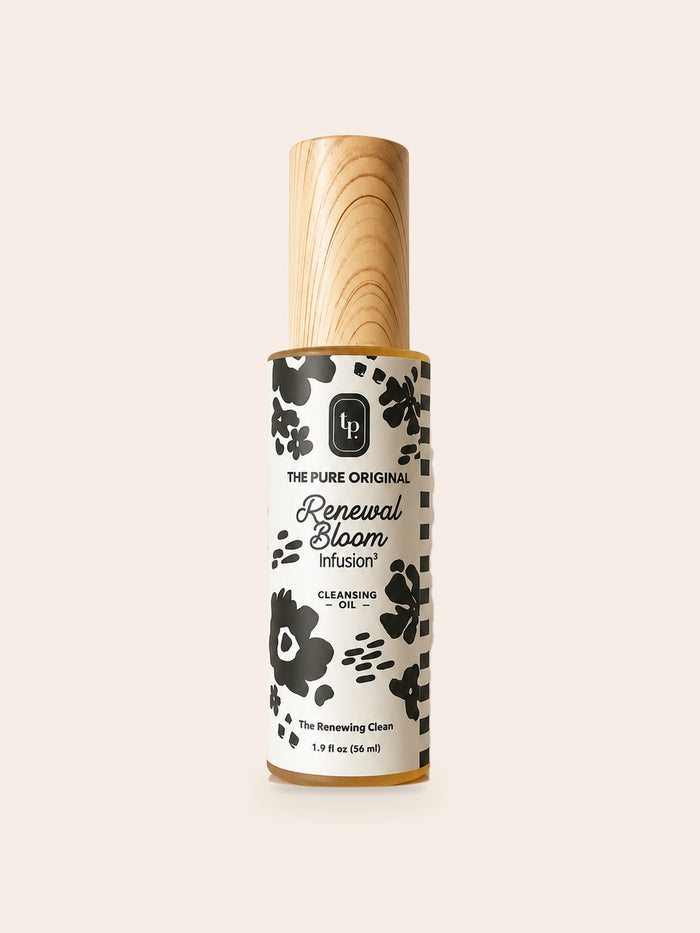 Renewal Bloom Cleansing Oil: tall bottle, wood-grain cap, white label with bold black flowers