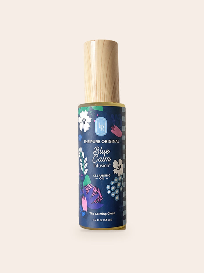 Blue Calm Cleansing Oil: tall bottle, wood-grain cap, navy label with white, pink and purple flowers