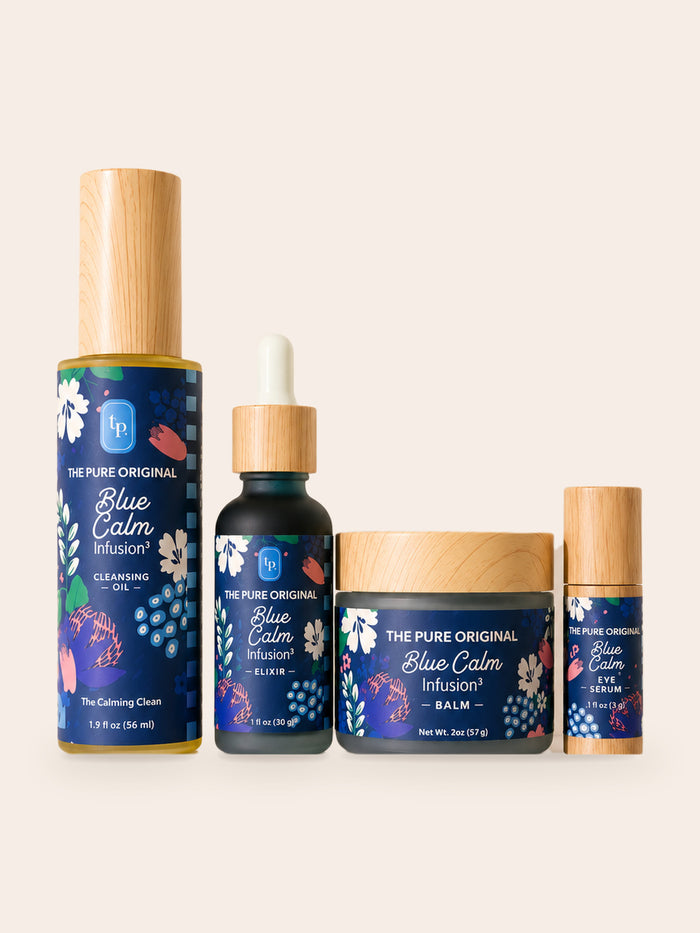 Blue Calm Collection: cleansing oil, elixir, balm jar and eye serum in a row, navy floral labels