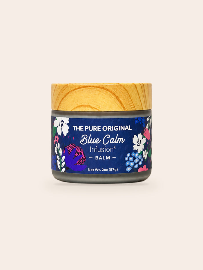 Blue Calm Balm: frosted glass jar, wood-grain lid, navy floral label, 2 oz